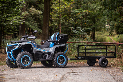 All-terrain vehicle with a trailer in a forest setting